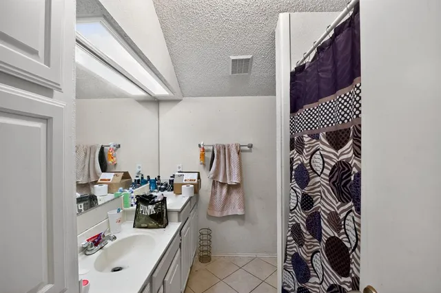 a bathroom with a sink toilet mirror and shower