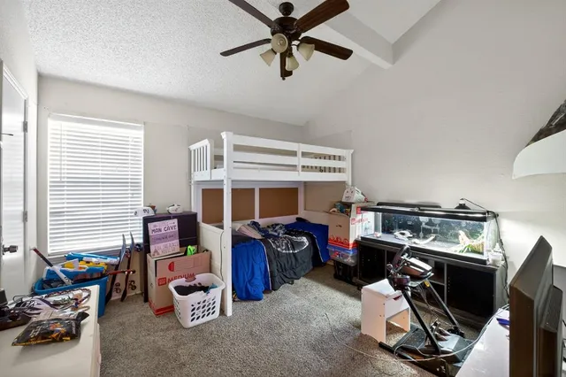 a bedroom with furniture and a flat screen tv