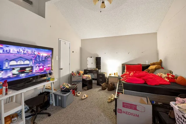 a bed room with a bed and a mirror