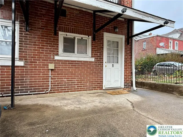 a view of outdoor space and front door of house