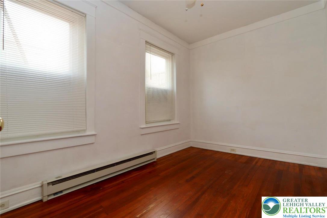 728 East 6th Street, Unit 1 Bethlehem, PA 18015 - Photo 9 of 15 a view of an empty room with wooden floor and a window