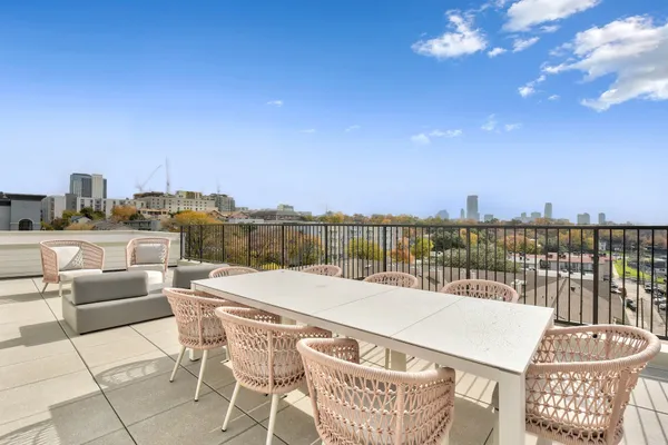 a terrace with outdoor seating city view and ocean view