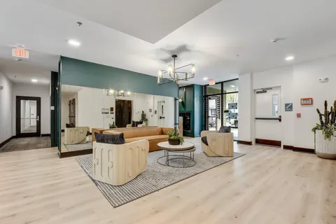 a living room with furniture and a chandelier
