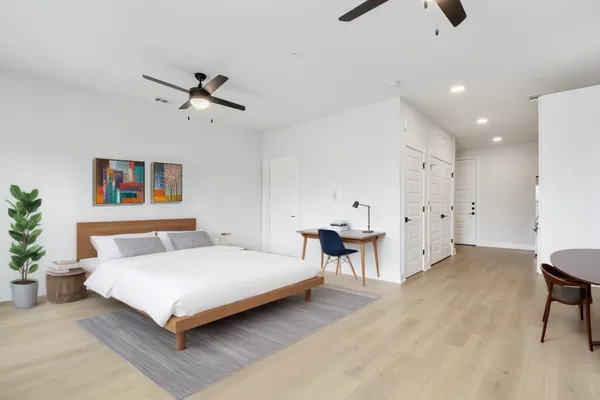 a bedroom with a bed and a table