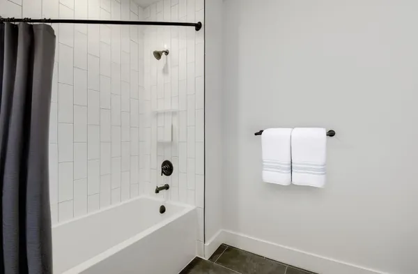 a bathroom with a bathtub and shower