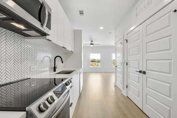 a view of a kitchen with a sink and cabinets