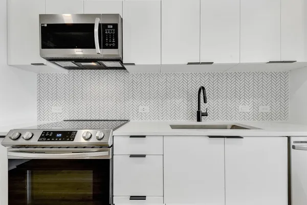 a kitchen with a stove and a microwave