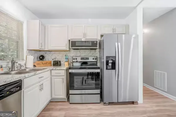 a kitchen with a refrigerator and a sink
