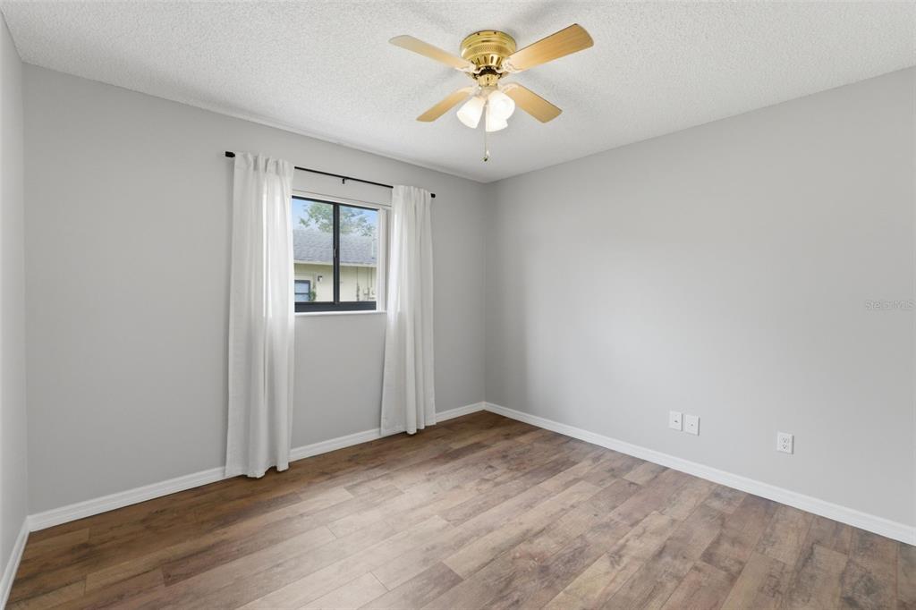 4966 Keysville Avenue Spring Hill, FL 34608 - Photo 33 of 48 an empty room with a window and a ceiling fan