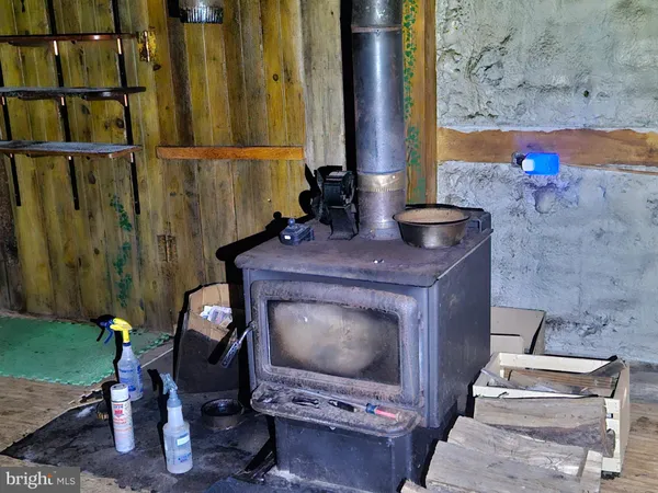 a room with water heater and wooden racks