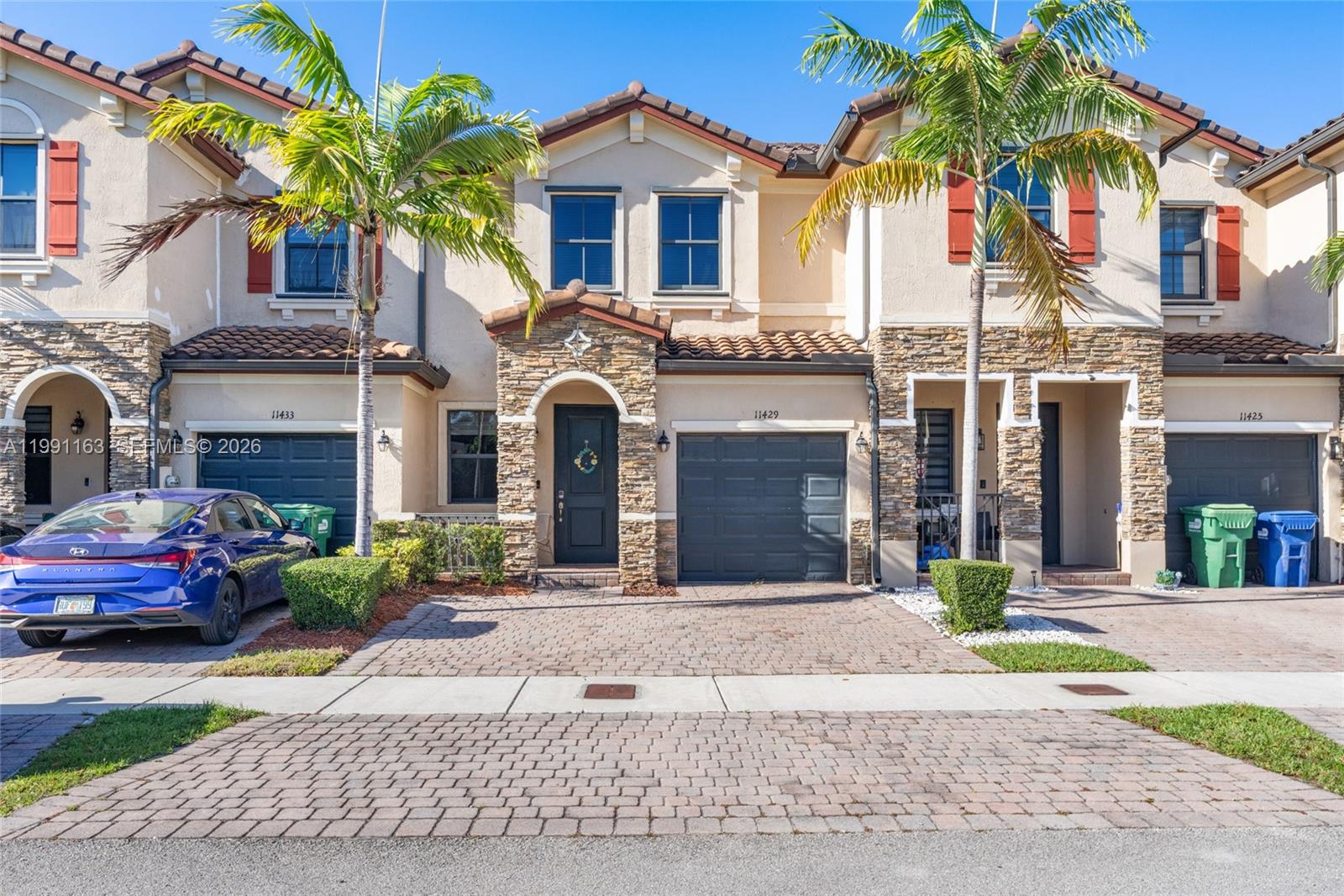 11429 Southwest 253rd Street Homestead, FL 33032 - Photo 1 of 30 a front view of a house with a garden
