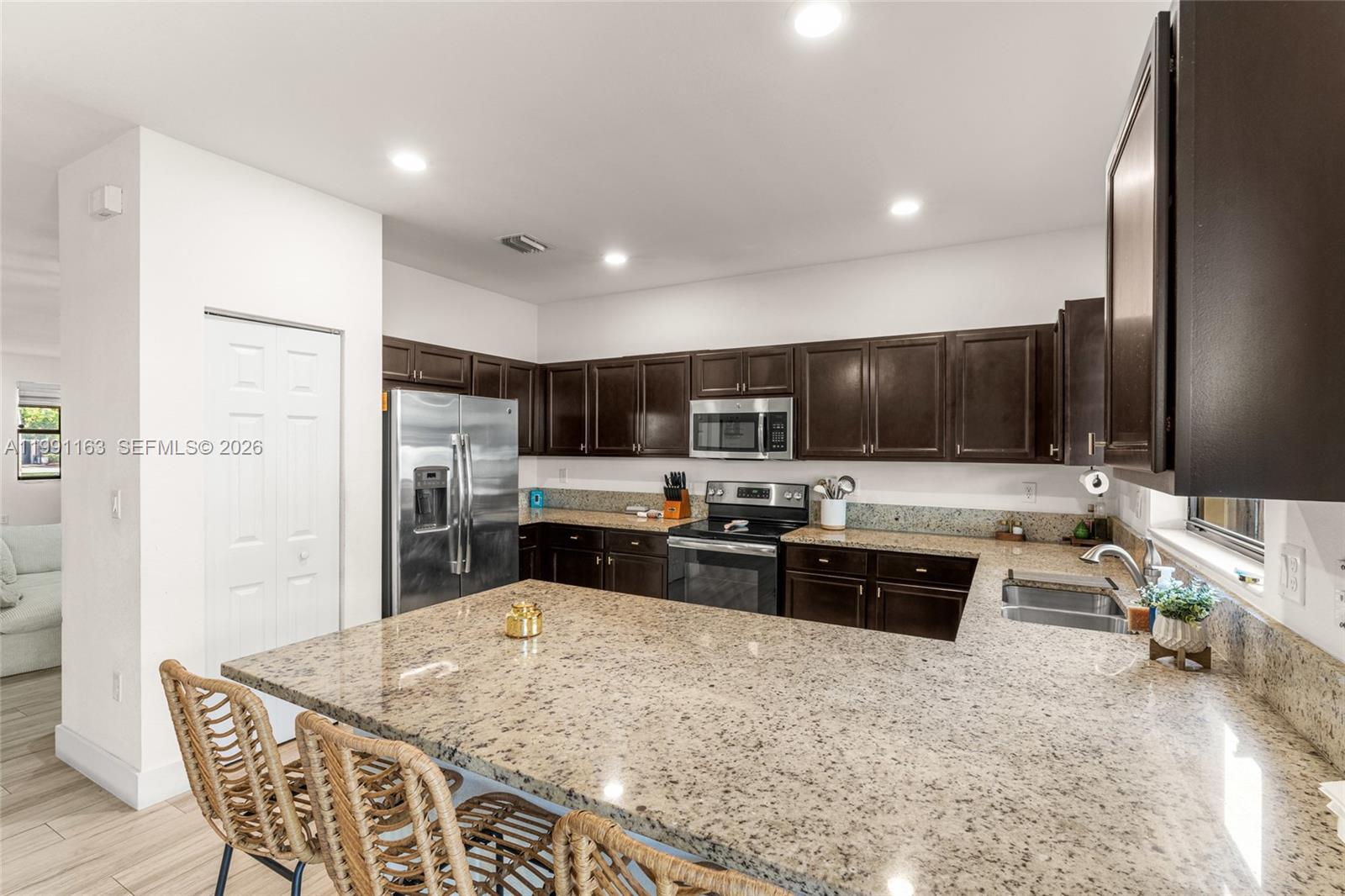 11429 Southwest 253rd Street Homestead, FL 33032 - Photo 11 of 30 a large kitchen with stainless steel appliances and a refrigerator