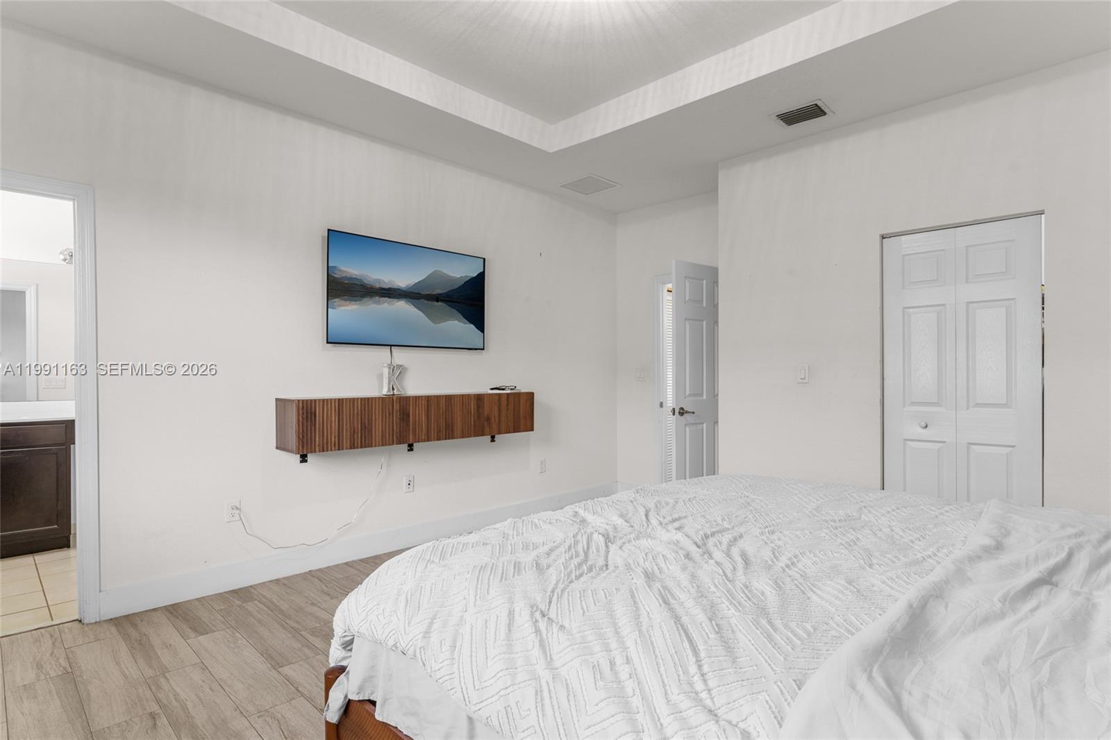 11429 Southwest 253rd Street Homestead, FL 33032 - Photo 16 of 30 a bedroom with a bed and a flat screen tv