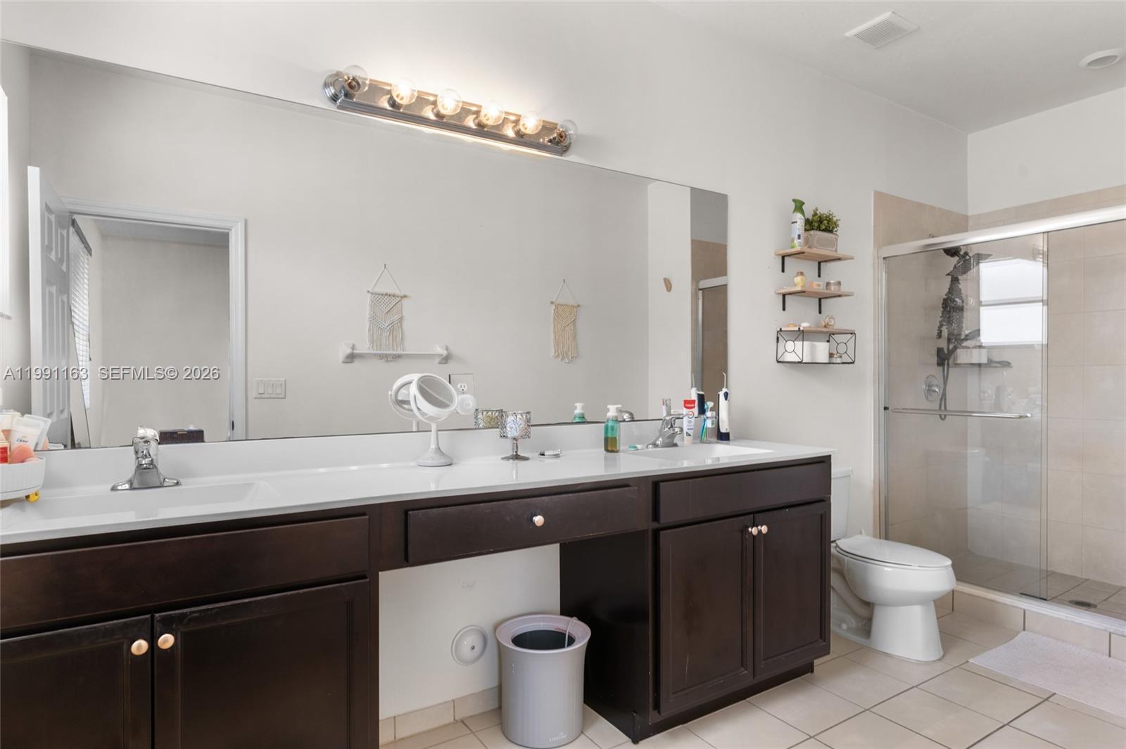 11429 Southwest 253rd Street Homestead, FL 33032 - Photo 17 of 30 a bathroom with a toilet sink and mirror