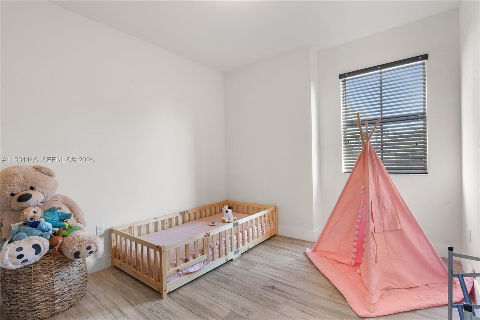 11429 Southwest 253rd Street Homestead, FL 33032 - Photo 20 of 30 a bedroom with a bed and wooden floor