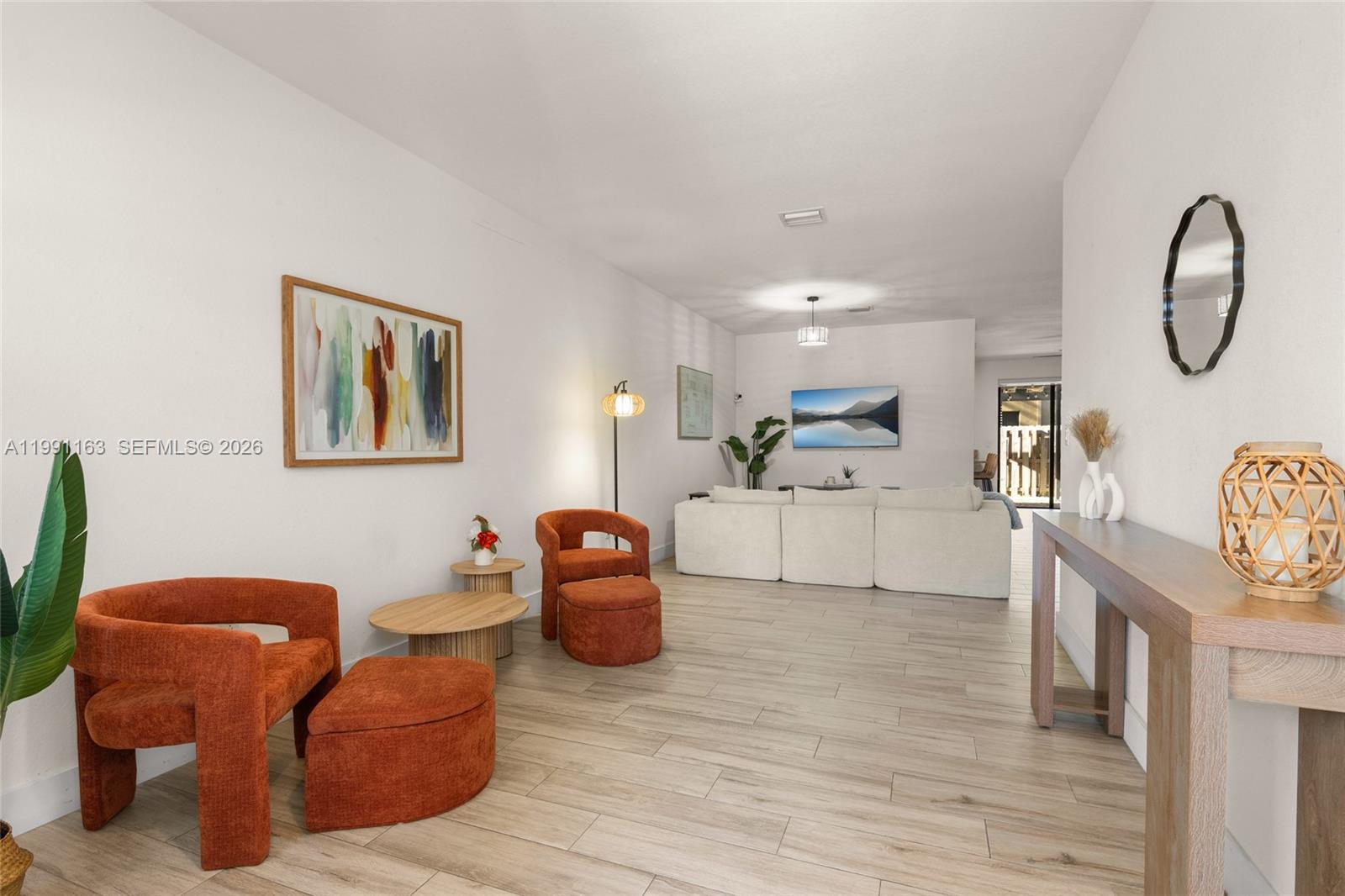 11429 Southwest 253rd Street Homestead, FL 33032 - Photo 5 of 30 a living room with furniture a table and wooden floor