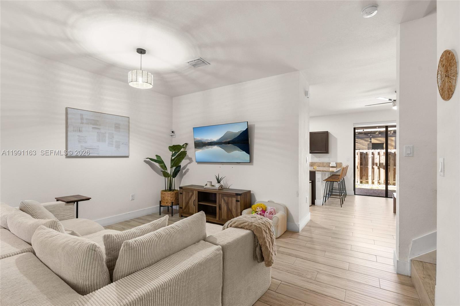 11429 Southwest 253rd Street Homestead, FL 33032 - Photo 7 of 30 a living room with furniture wooden floor and a flat screen tv
