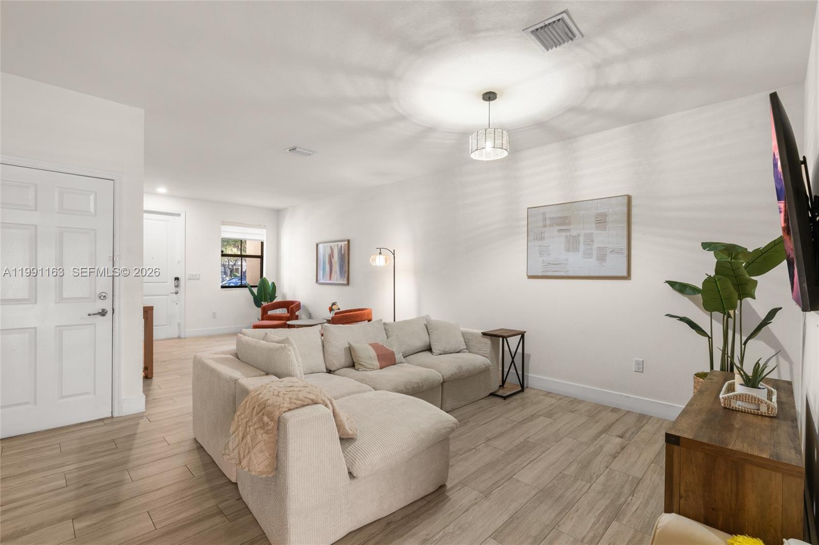 11429 Southwest 253rd Street Homestead, FL 33032 - Photo 8 of 30 a living room with furniture and a wooden floor