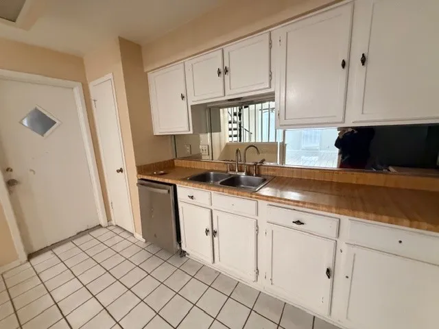 a kitchen with a stove a sink and a refrigerator