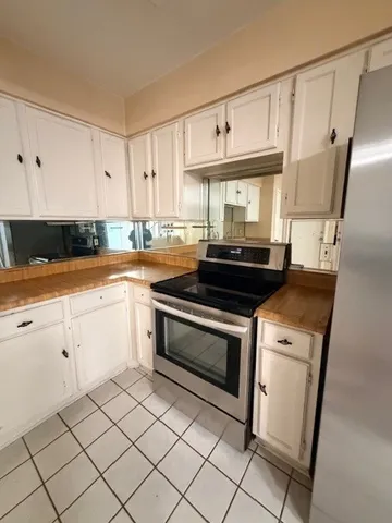 a kitchen with stainless steel appliances a refrigerator and a stove top oven