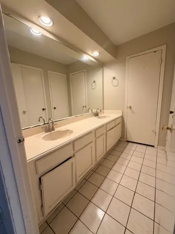 an empty room with a ceiling fan and windows