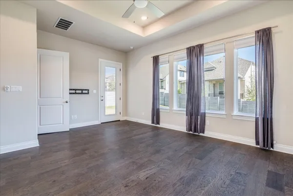 a view of an empty room with glass door and balcony