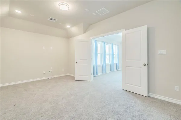 an empty room with windows and closet
