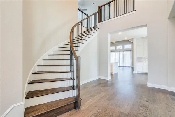 a view of entryway and hall with wooden floor