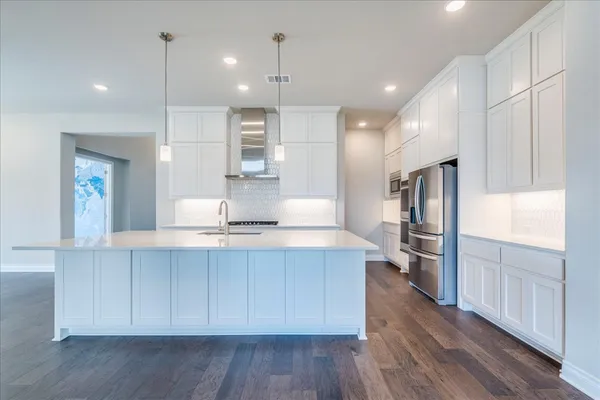 a large kitchen with stainless steel appliances kitchen island a large island in the center