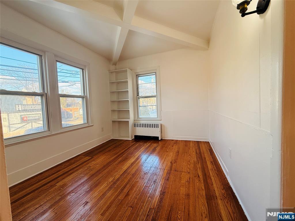 86 West Main Street, Unit FIRST Bergenfield, NJ 07621 - Photo 16 of 23 a view of an empty room with wooden floor and window