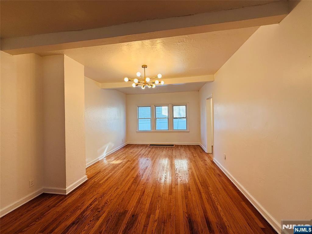 86 West Main Street, Unit FIRST Bergenfield, NJ 07621 - Photo 19 of 23 a view of a room with wooden floor and chandelier