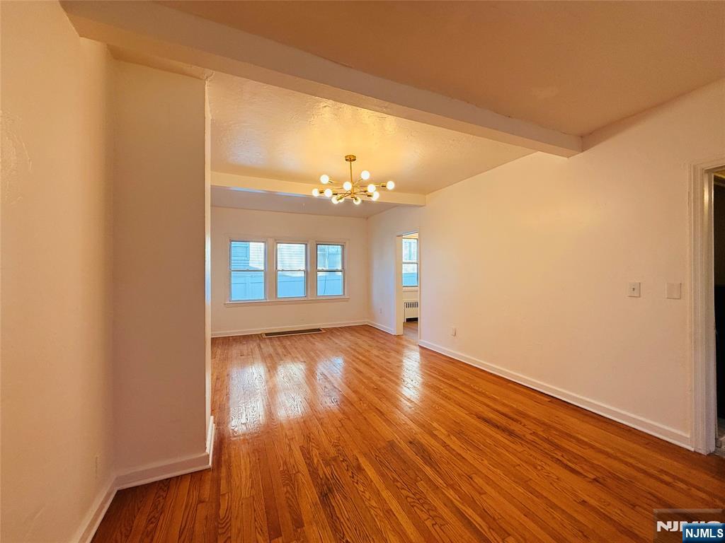 86 West Main Street, Unit FIRST Bergenfield, NJ 07621 - Photo 2 of 23 a view of a room with wooden floor and chandelier