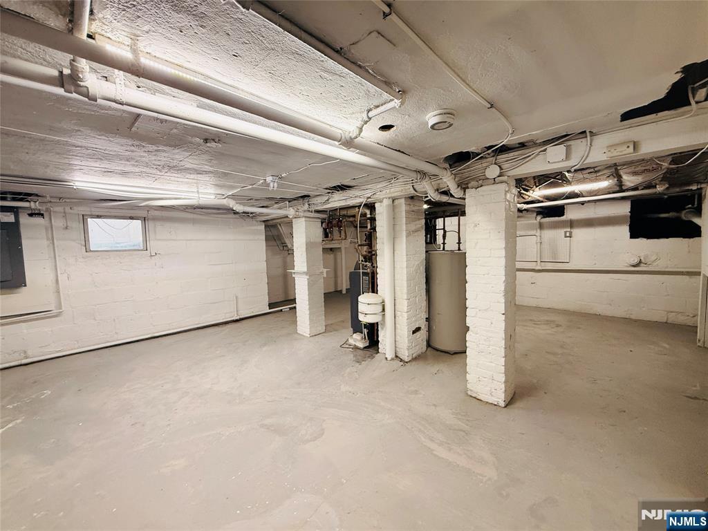 86 West Main Street, Unit FIRST Bergenfield, NJ 07621 - Photo 22 of 23 a view of a refrigerator in an empty room