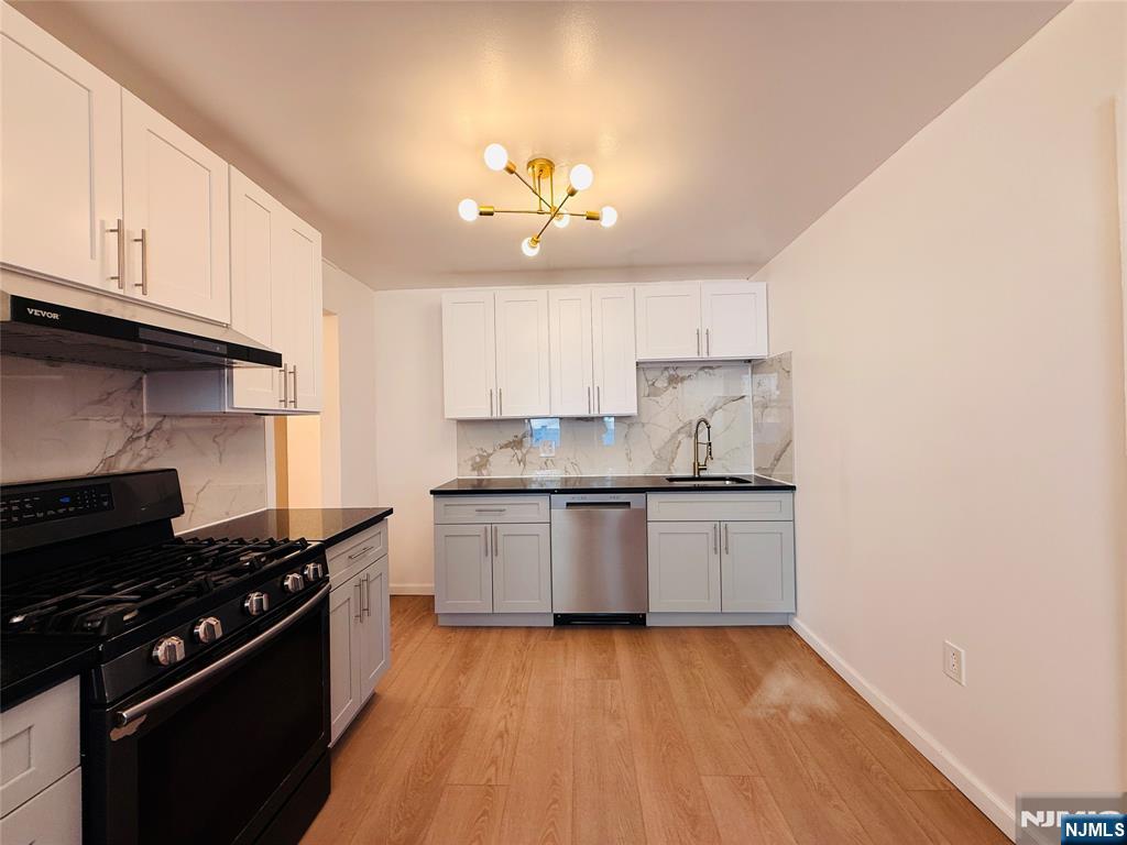 86 West Main Street, Unit FIRST Bergenfield, NJ 07621 - Photo 4 of 23 a kitchen with a sink stove and cabinets