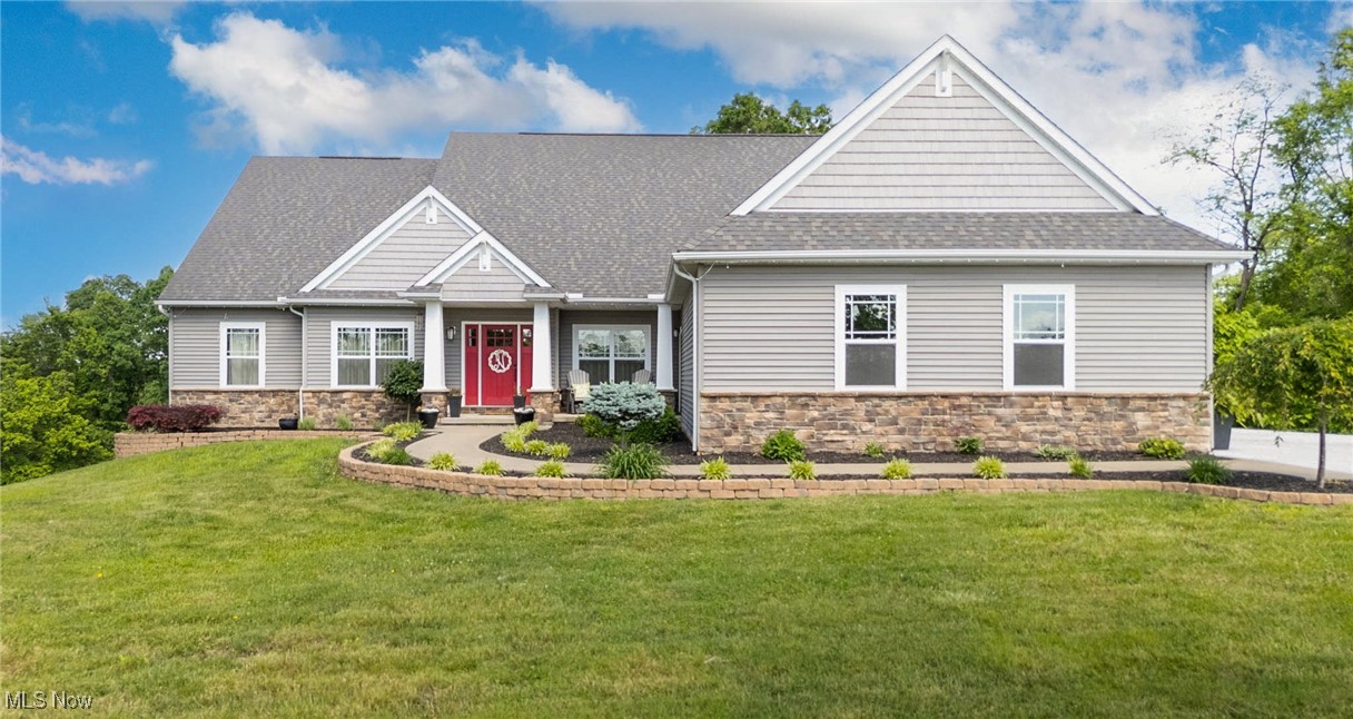 2851 Barnett Ridge Road Fleming, OH 45729 - Photo 1 of 40 Craftsman-style house featuring stone siding, a front yard, and roof with shingles