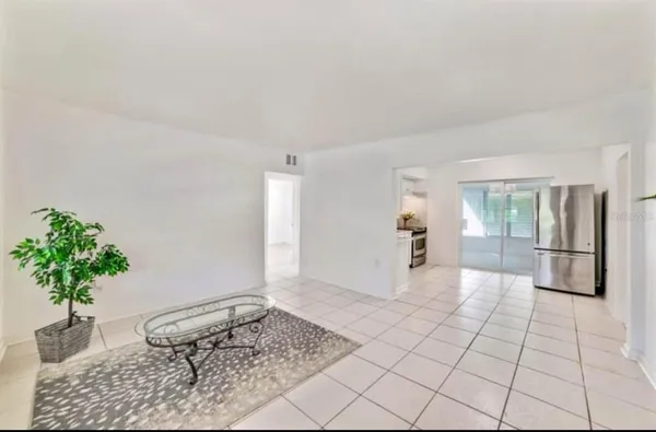 a living room with furniture and a potted plant