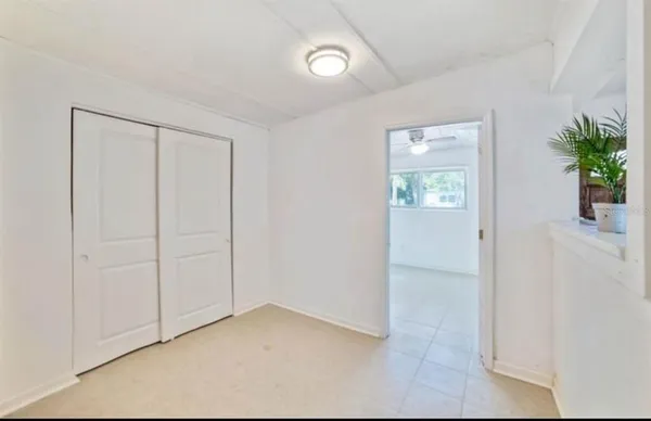 an empty room with windows and closet