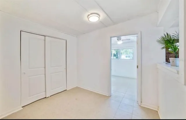 an empty room with windows and closet