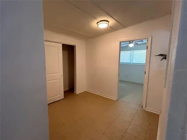 an empty room with closet and mirror