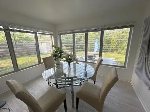 a dining room with furniture and window