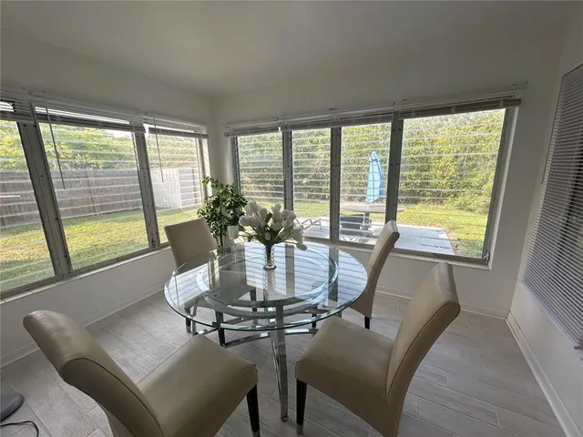 a dining room with furniture and window