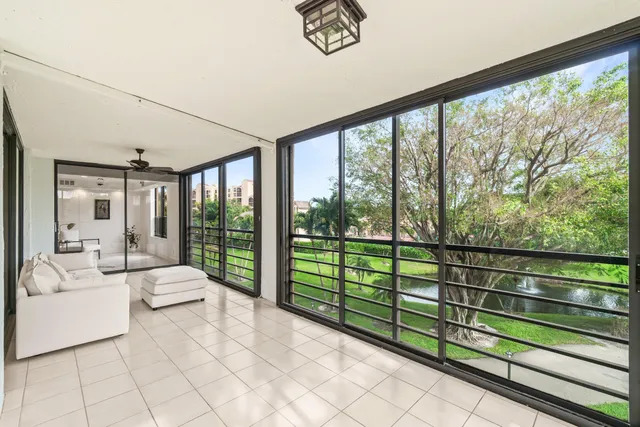 a bedroom with furniture and large windows