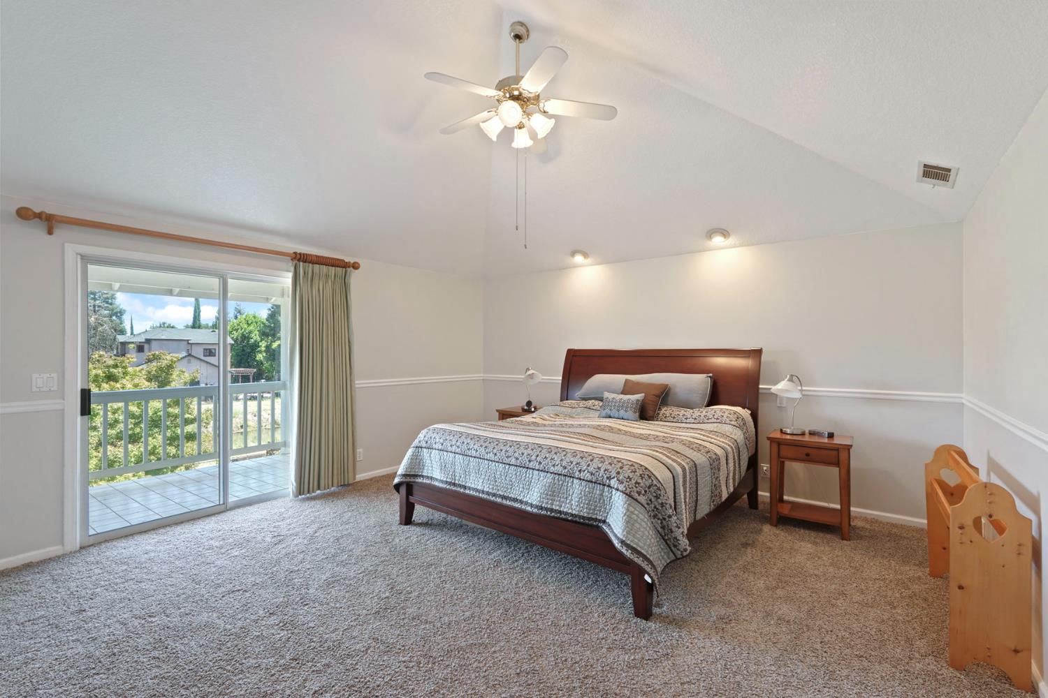 18432 Ironstone Street Woodbridge, CA 95258 - Photo 29 of 50 The spacious primary bedroom with volume ceiilngs features a slider with balcony.