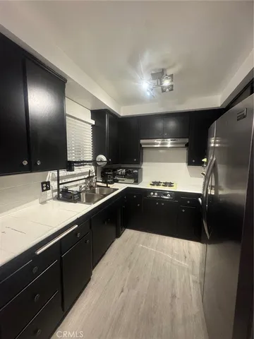 a black and white kitchen with a sink