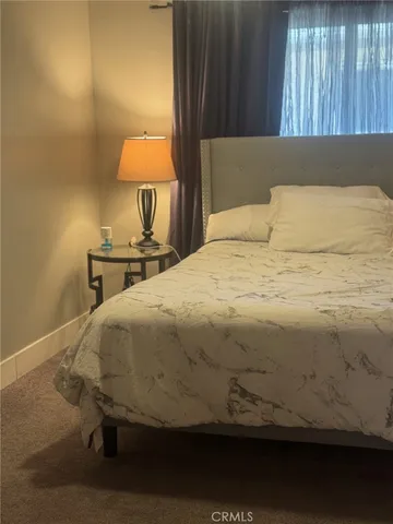 a bedroom with a bed and window