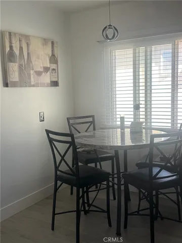 a view of a dining room with furniture and a large window