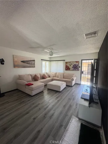 a living room with furniture window and wooden floor