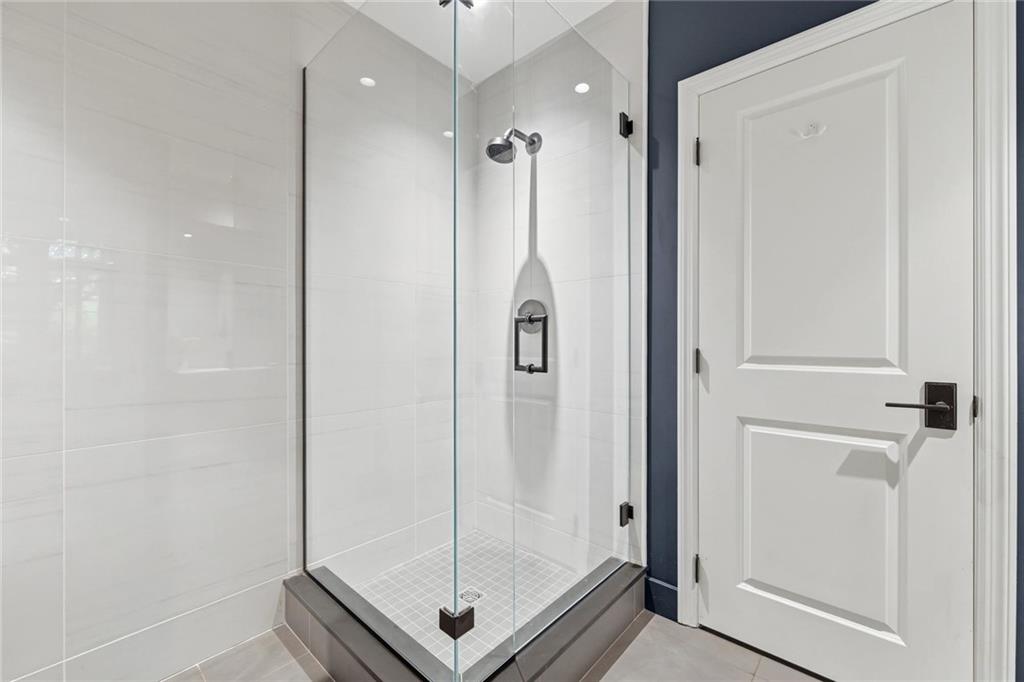 810 Persimmon Road Sewickley, PA 15143 - Photo 42 of 49 The lower-level bath's walk-in glass shower with frameless enclosure completes the suite's amenities with the same refined finishes found throughout the home.