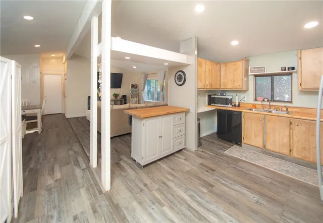 a kitchen with a sink refrigerator and microwave