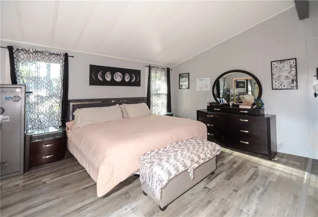 a bedroom with a large bed and a view of bedroom